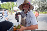 И только один мужик, набрав полный фургон кокосов, усердно сверлит их и продаёт туристам по три доллара.