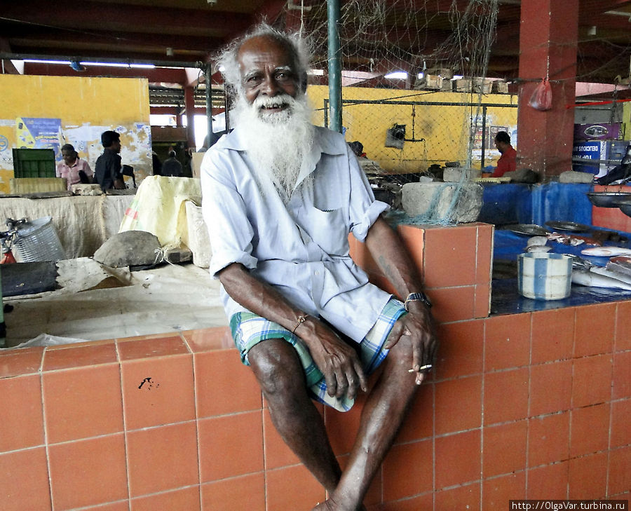 Колоритный дедуля — продавец рыбы, завидев фотоаппарат, сразу же уселся на прилавок, чтобы его лучше было видно Тринкомали, Шри-Ланка