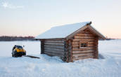 Снегоход и деревянная купальня на Святом озере