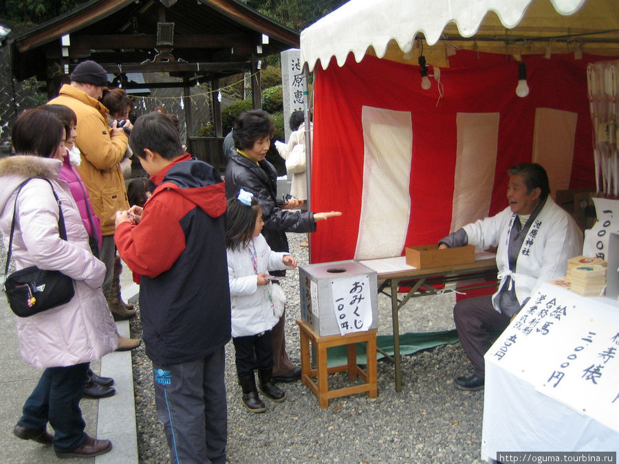 Люди тянут жребий, в котором пытаются узнать, что их ждёт в этом году Япония