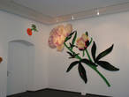 Здесь проводятся разные выставки. Это — выставка вязаных цветов. Огромные, во всю стену цветы из очень ярких тканей.