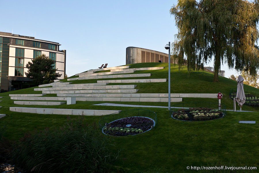 Премиум клабхаус — одна из инсталляций с сумасшедшим экспонатом.
С одной стороны он выглядит как холм с надгробием. Вольфсбург, Германия
