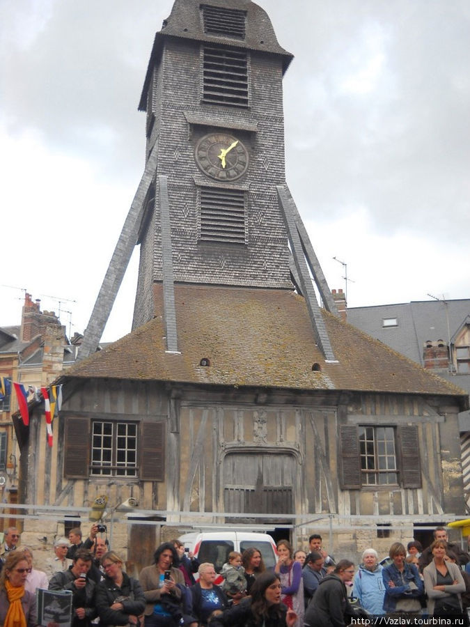 Отдельно стоящая колокольня; внизу видны горожане, собравшиеся к церкви на празднование