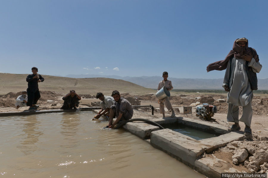 Ах да, единственное, что здесь автоматизировано — это водокачка. Из скважины воду собирают в бассейн на верху холма. Оттуда она по желобкам поступает на нижнии уровне, где из глины делают заготовки. В этой же воде работники моются и купаются. Баграм, Афганистан