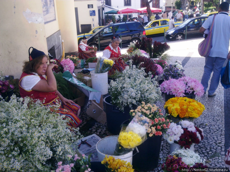Фуншал. У входа на городской рынок. Цветочницы в национальных костюмах. Снято на телефон. Регион Мадейра, Португалия
